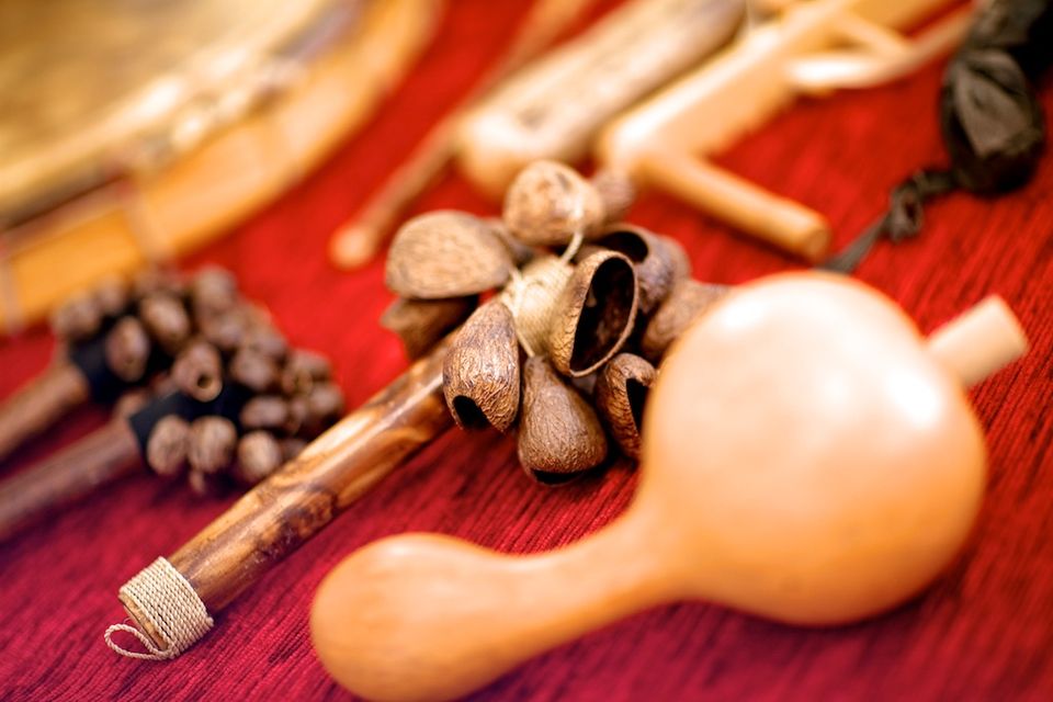 Close-up of shaman's rattles and seed shakers on red cloth
