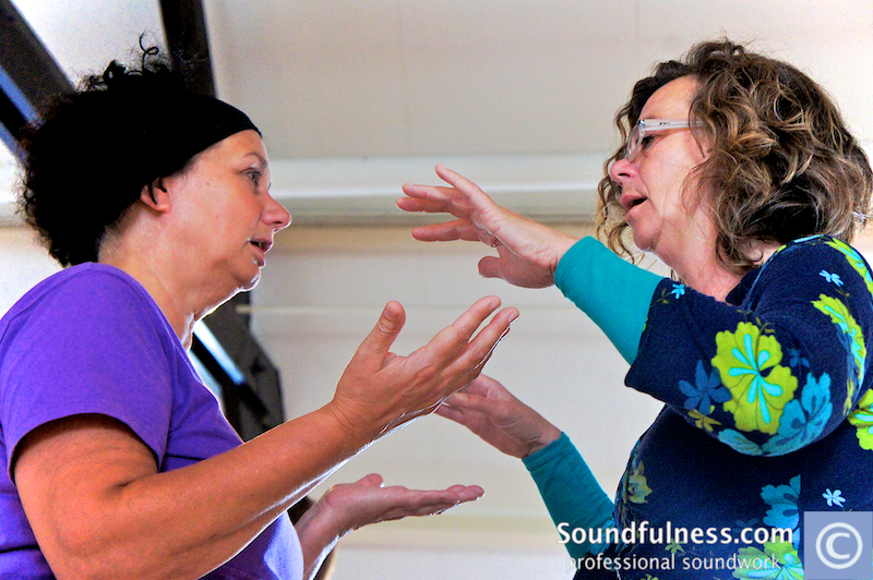 Two women in animated hand-gesture dialogue during training