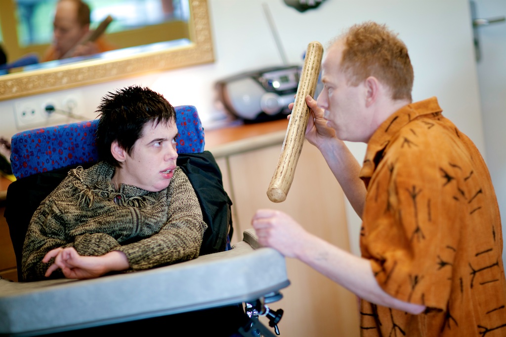 Coen using a wooden instrument in a care setting