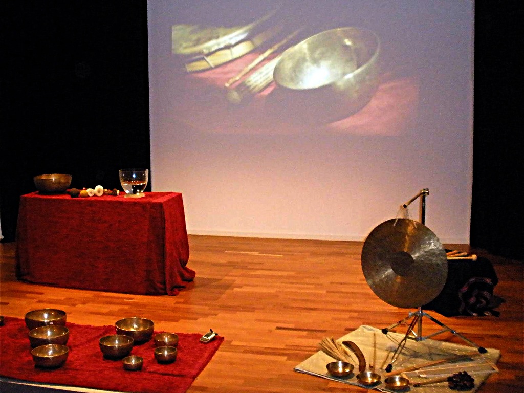 Theatre stage set with singing bowls, gong and projected bowl image on the back screen