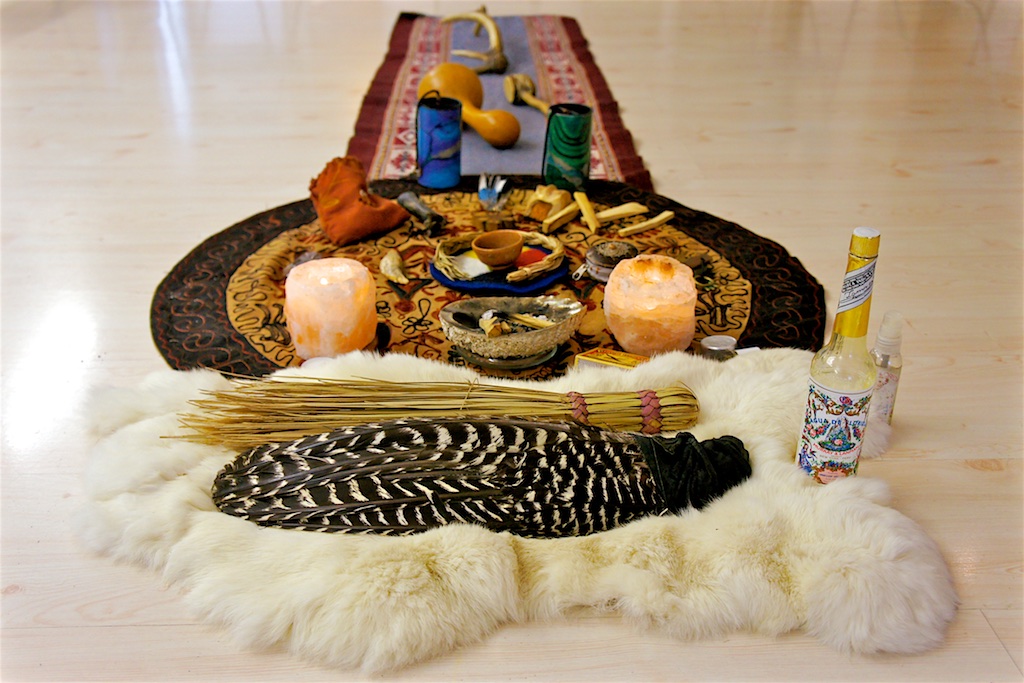 Ceremonial altar with feathers, salt lamps and offerings on sheepskin