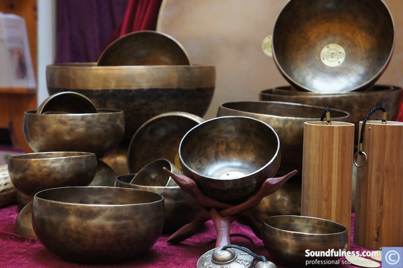 Close-up display of hand-hammered singing bowls, bamboo chimes and tingshas