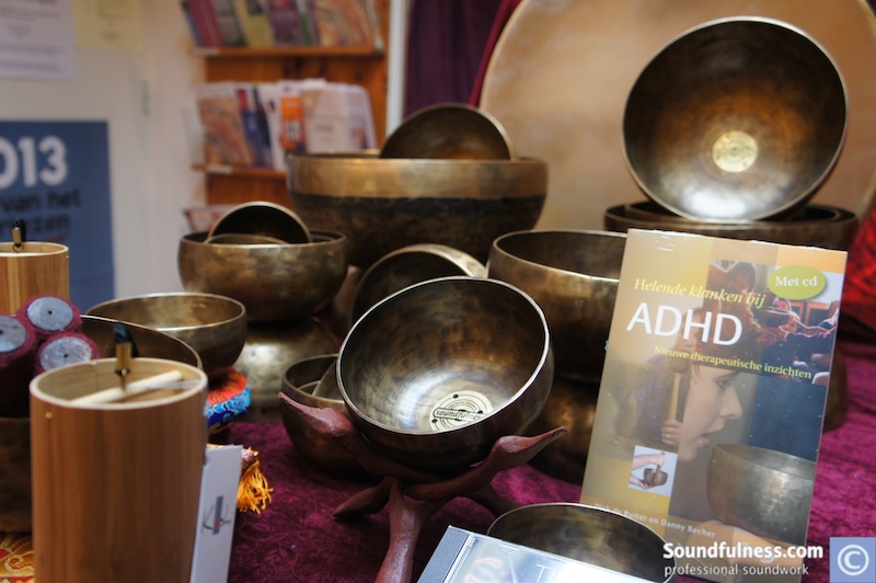Singing bowls, bamboo chimes and a book on healing sounds for ADHD displayed at a fair