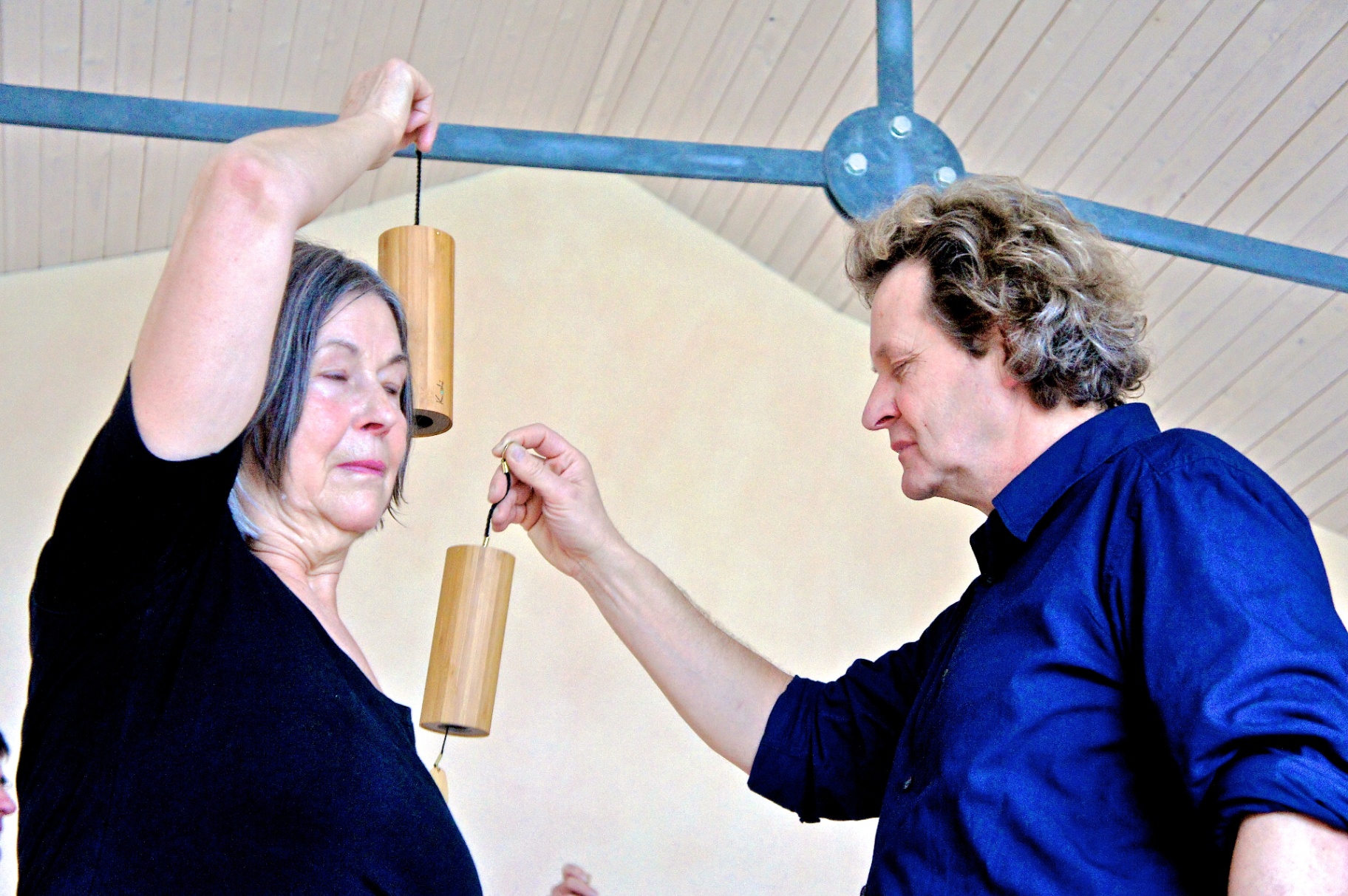 Coen playing Koshi chimes for a participant with closed eyes
